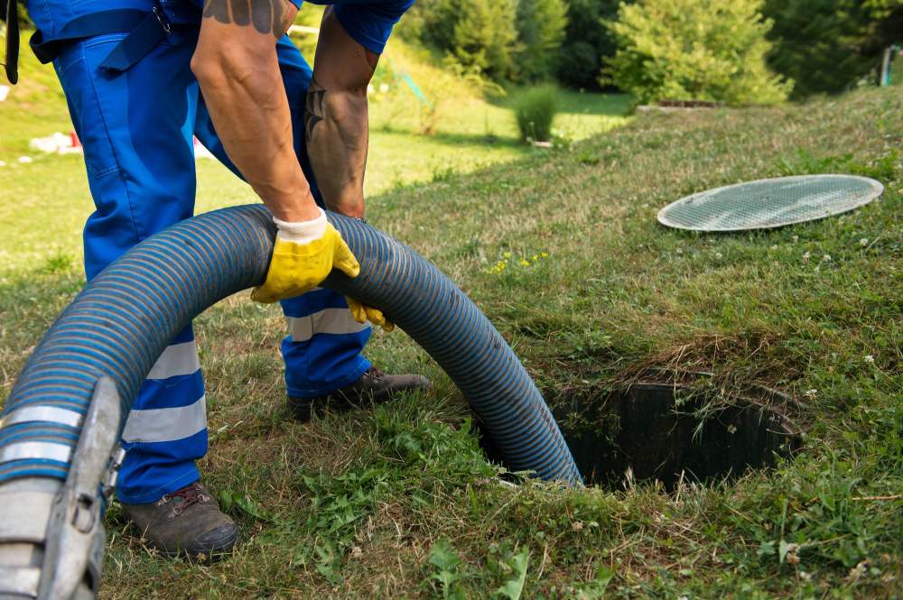 Gentleman emptying and cleaning household septic tank - Gotta Go Green Vero Beach, FL 